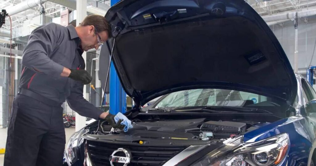 How Much is an Oil Change at Nissan - A Nissan Technician Checking Oil Level